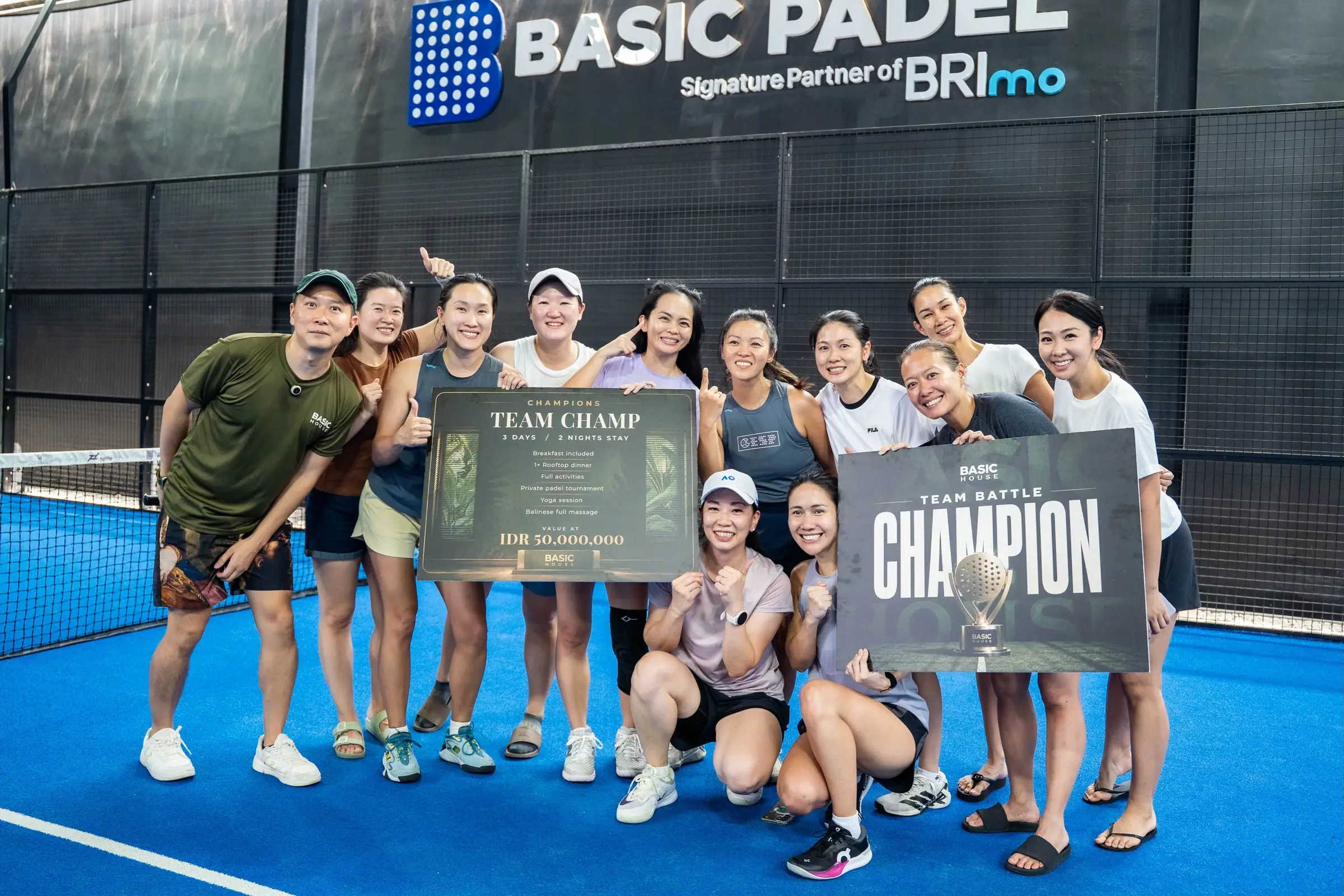 Team champions celebrating on the blue court