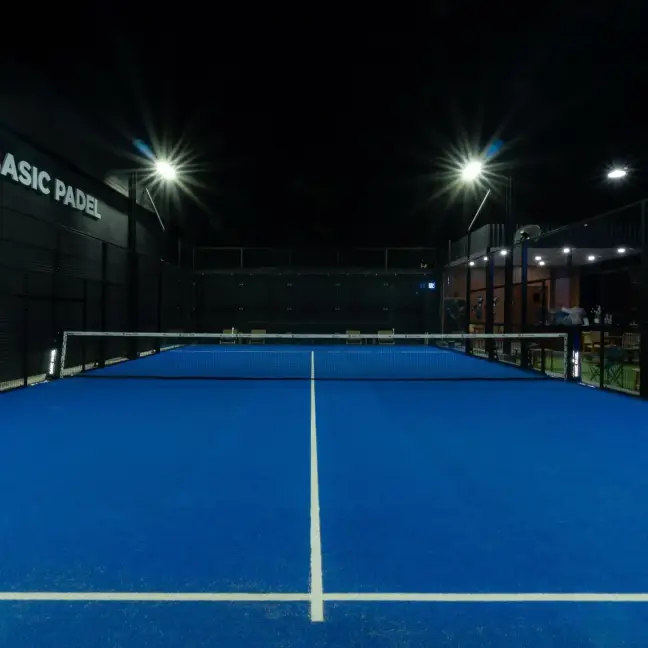 Empty blue court under floodlights