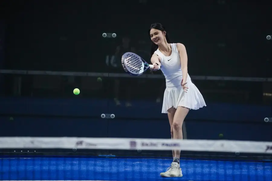 Player hitting a forehand at night